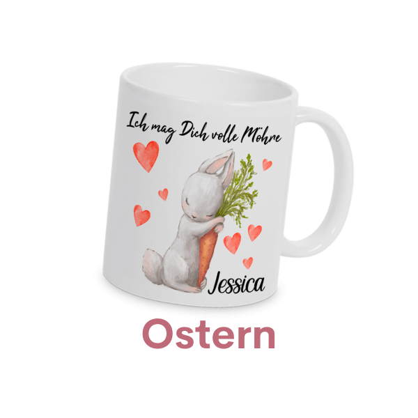Kategoriebild für Kategorieübersicht. Weiße Tasse mit süßem Osterdesign: Ein liebevoller Hase umarmt eine Möhre, umgeben von roten Herzen. Die Aufschrift „Ich mag Dich volle Möhre“ macht sie zu einem perfekten Geschenk für Ostern. Mit Personalisierungsmöglichkeit für den Namen.